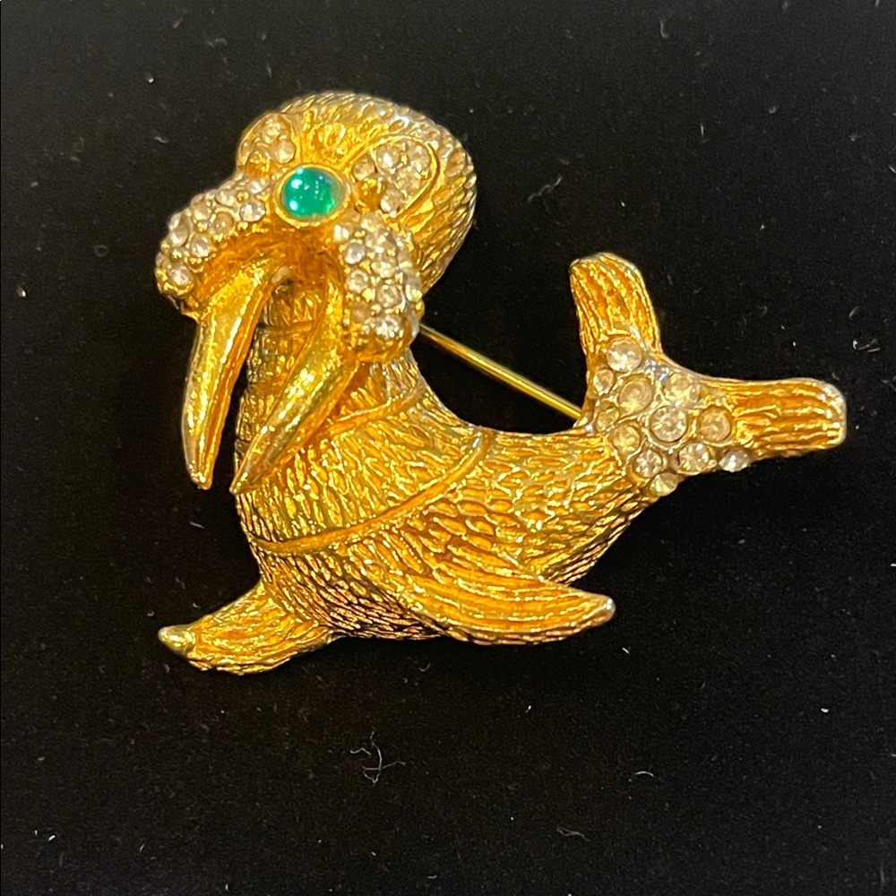 Kenneth J. Lane Gold and Crystal Walrus Brooch with Green nose. Never worn.
